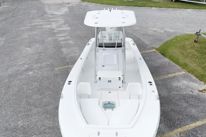 Slide: The Image of 2027 BlackJack 256 Coastal boat, white exterior, parked on asphalt with grass nearby. - 3