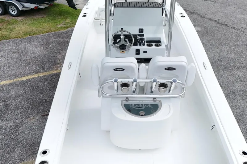 Slide: The Image of 2027 BlackJack 256 Coastal boat interior with steering console and seating. - 9