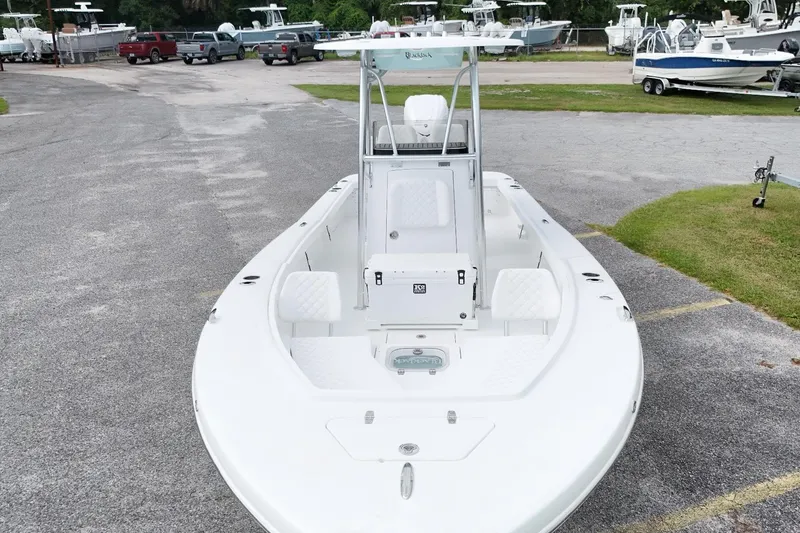 Slide: The Image of 2027 BlackJack 256 Coastal boat in a marina, showcasing sleek design and spacious deck. - 5