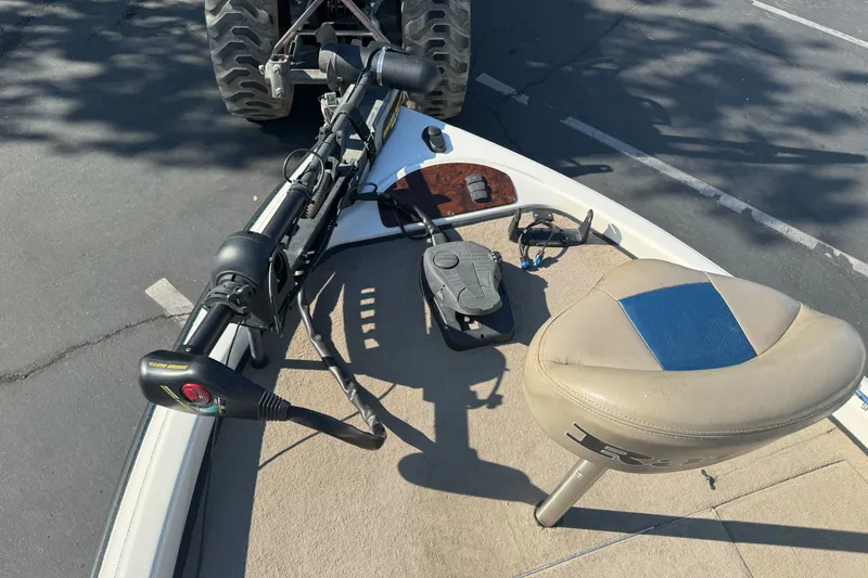 Slide: The Image of 2004 Ranger 185 VS boat deck with trolling motor and seat in parking lot. - 8