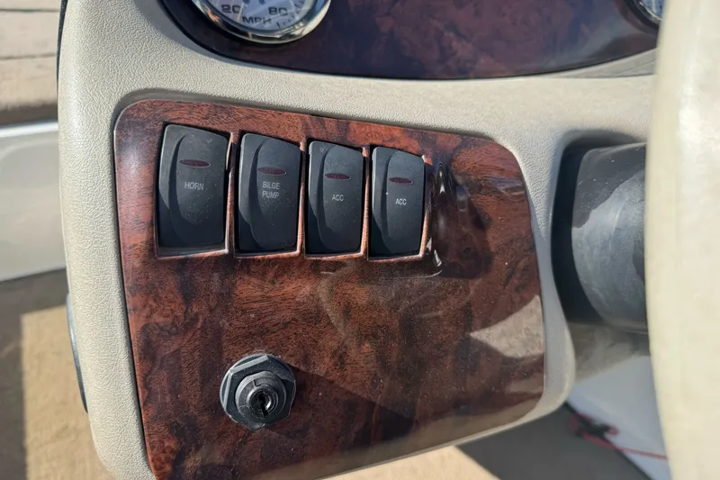 Slide: The Image of Dashboard switches of a 2004 Ranger 185 VS boat, featuring horn and bilge pump controls. - 13