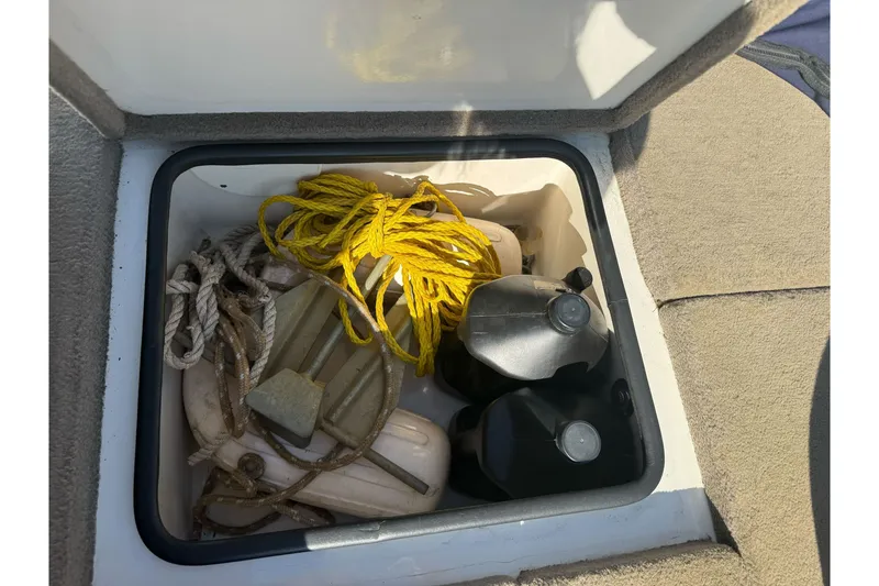 Slide: The Image of Storage compartment in a 2004 Ranger 185 VS boat with ropes and containers. - 25
