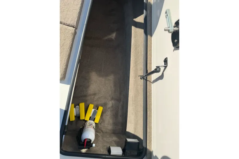 Slide: The Image of Storage compartment of 2004 Ranger 185 VS boat with safety equipment. - 21