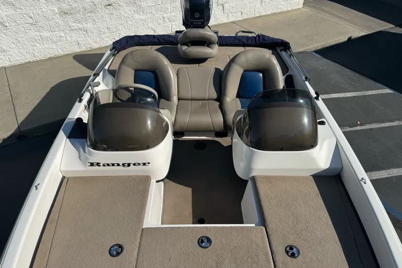 Slide: The Image of 2004 Ranger 185 VS boat interior with dual consoles and seating. - 10