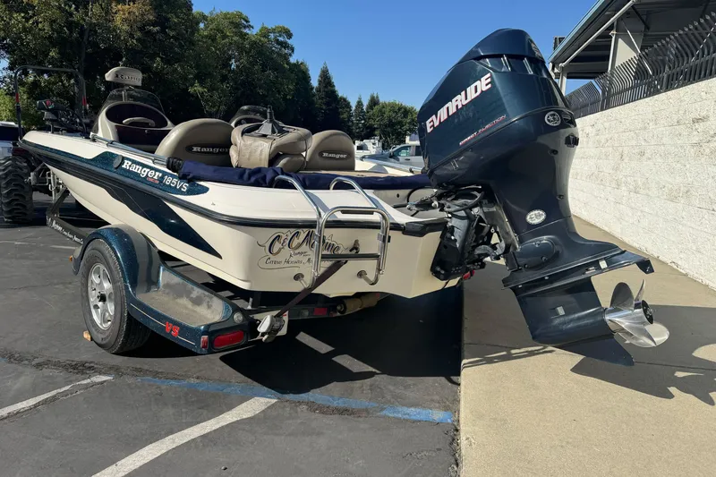 Slide: The Image of 2004 Ranger 185 VS boat with Evinrude motor on trailer in parking lot. - 6