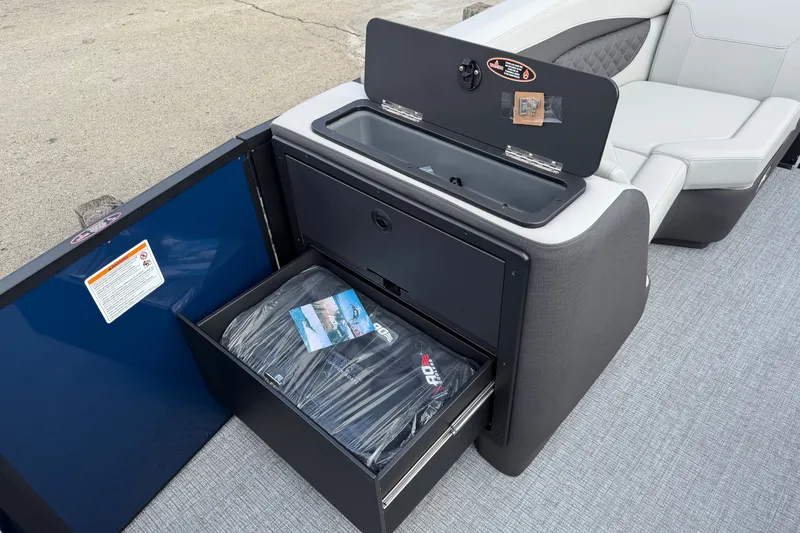 Slide: The Image of 2027 Harris Sunliner 210 boat interior with storage compartment and seating. - 7