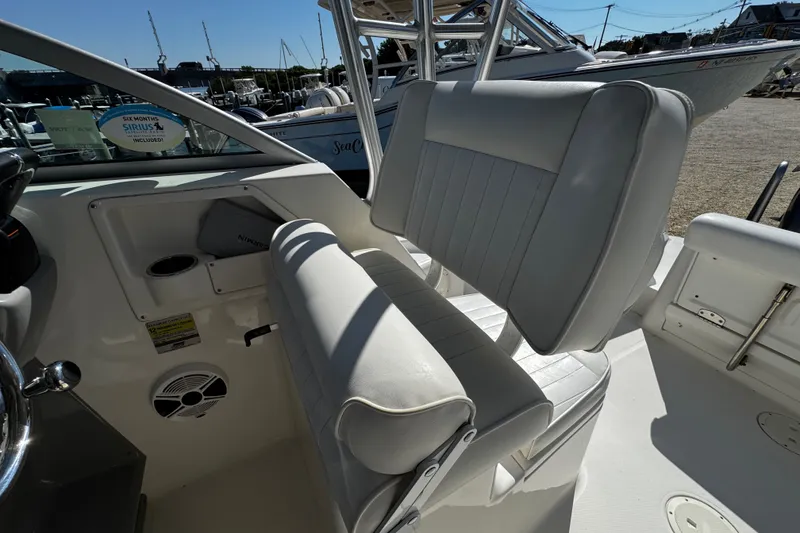 Slide: The Image of 2010 Robalo R265 Walkaround boat interior with white seating and steering area. - 31