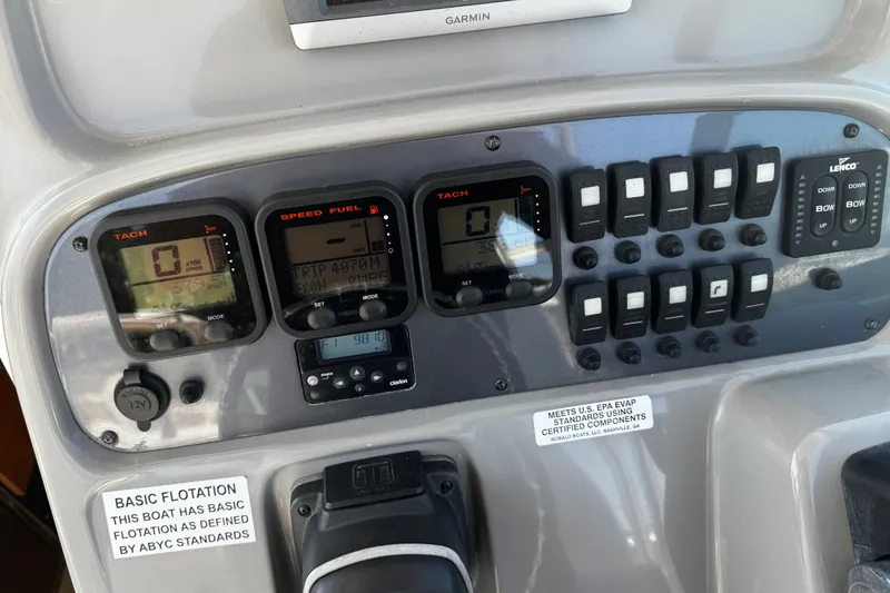 Slide: The Image of Dashboard of a 2010 Robalo R265 Walkaround boat with gauges and switches. - 47