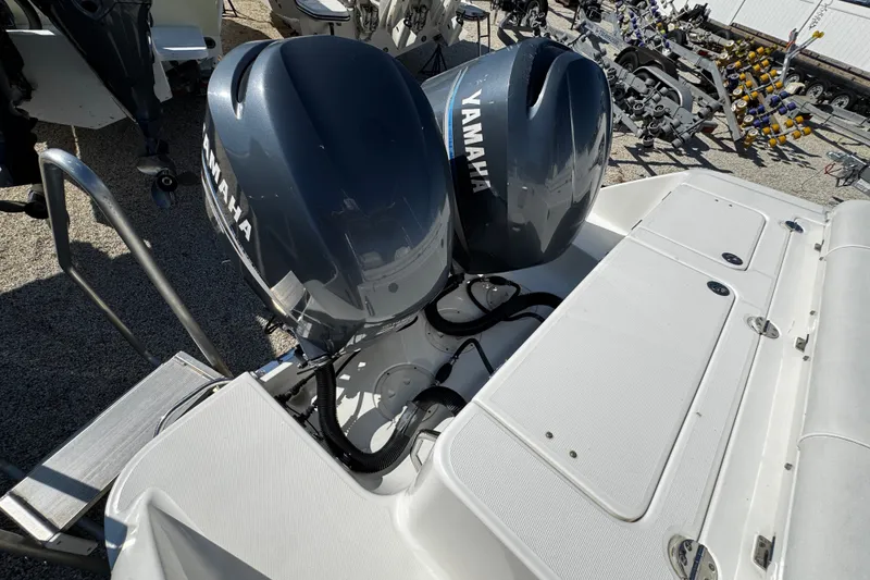 Slide: The Image of 2010 Robalo R265 Walkaround with dual Yamaha outboard engines, docked on gravel. - 15