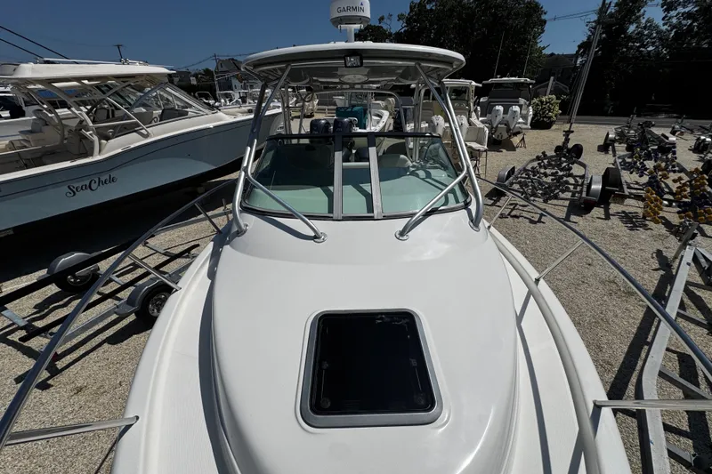 Slide: The Image of 2010 Robalo R265 Walkaround boat on display at a marina. - 50