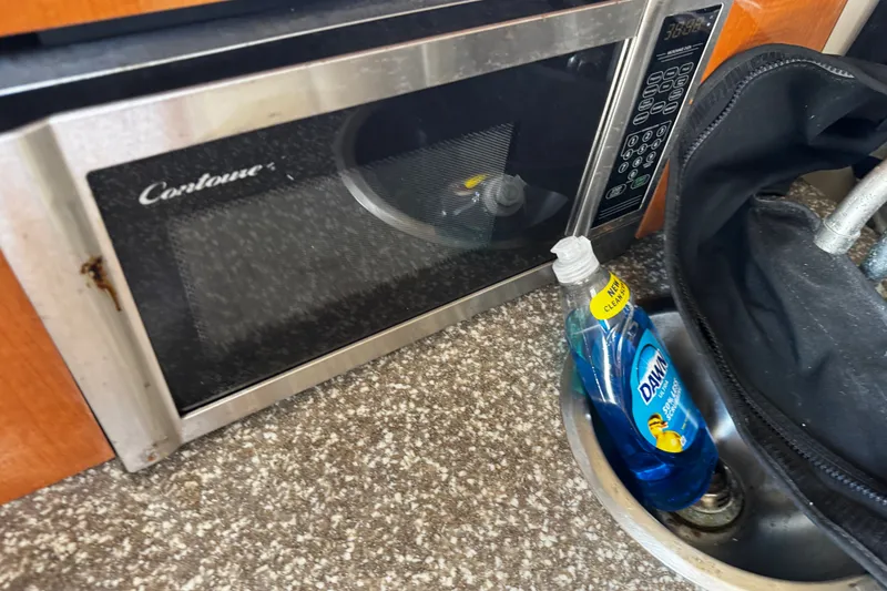 Slide: The Image of Microwave and sink area on 2010 Robalo R265 Walkaround boat. - 44