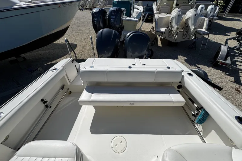 Slide: The Image of 2010 Robalo R265 Walkaround boat interior with seating and dual outboard engines. - 11