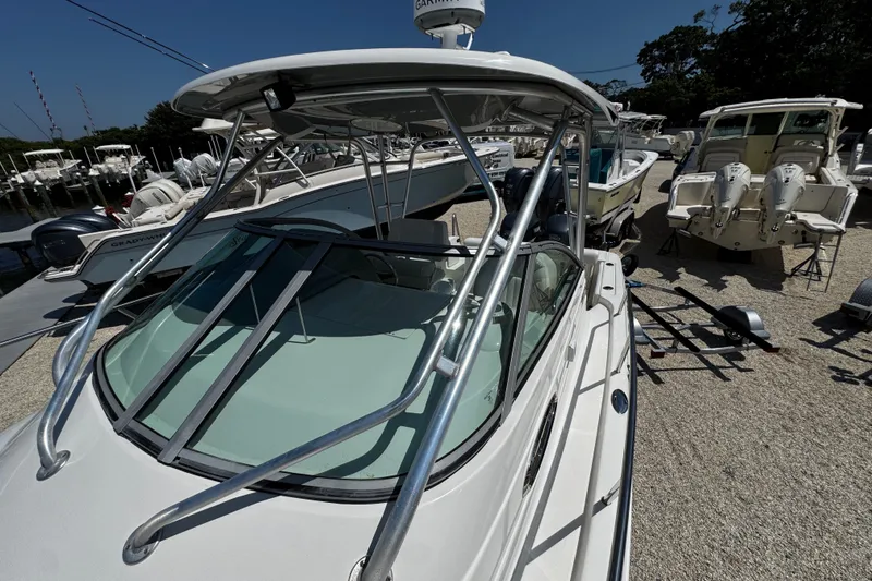 Slide: The Image of 2010 Robalo R265 Walkaround boat displayed in a marina setting. - 51