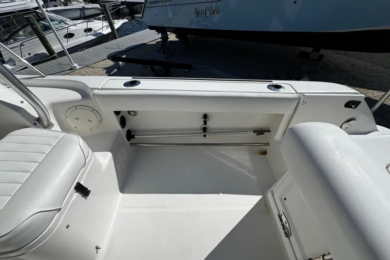 Slide: The Image of 2010 Robalo R265 Walkaround boat interior with seating and storage compartments. - 17