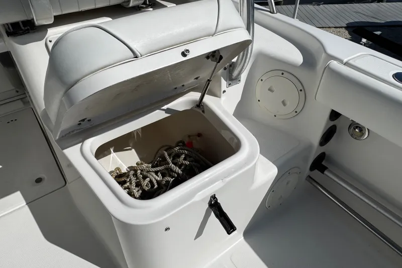 Slide: The Image of 2010 Robalo R265 Walkaround boat storage compartment with ropes inside. - 20