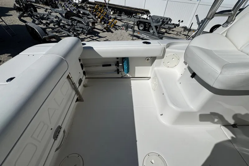 Slide: The Image of 2010 Robalo R265 Walkaround boat interior with white seating and storage compartments. - 18