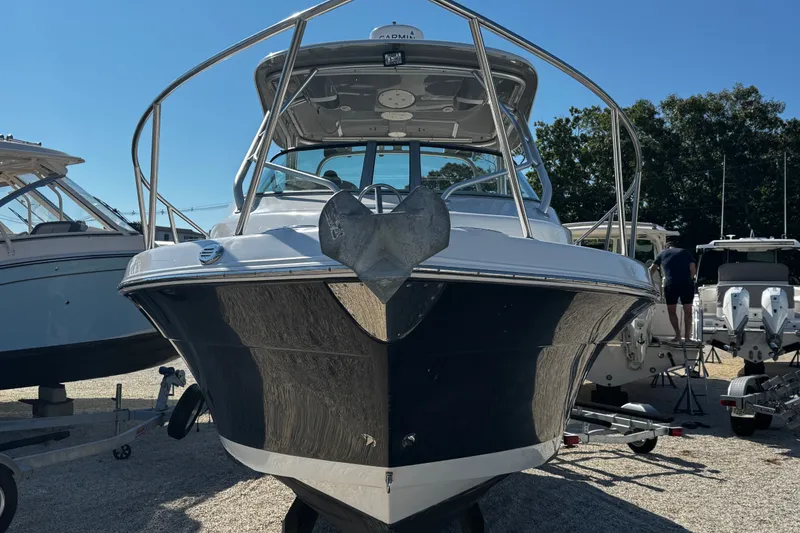 Slide: The Image of 2010 Robalo R265 Walkaround boat on display in a marina setting. - 2