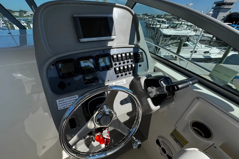 Slide: The Image of Helm of 2010 Robalo R265 Walkaround boat with steering wheel and control panel. - 24