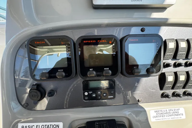 Slide: The Image of Dashboard of a 2010 Robalo R265 Walkaround boat with tachometer and fuel gauges. - 26