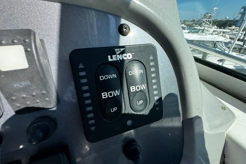 Slide: The Image of Control panel of a 2010 Robalo R265 Walkaround boat with Lenco trim tab switches. - 27