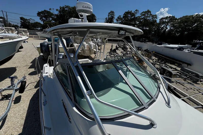 Slide: The Image of 2010 Robalo R265 Walkaround boat with Garmin radar, parked on a sunny day. - 52