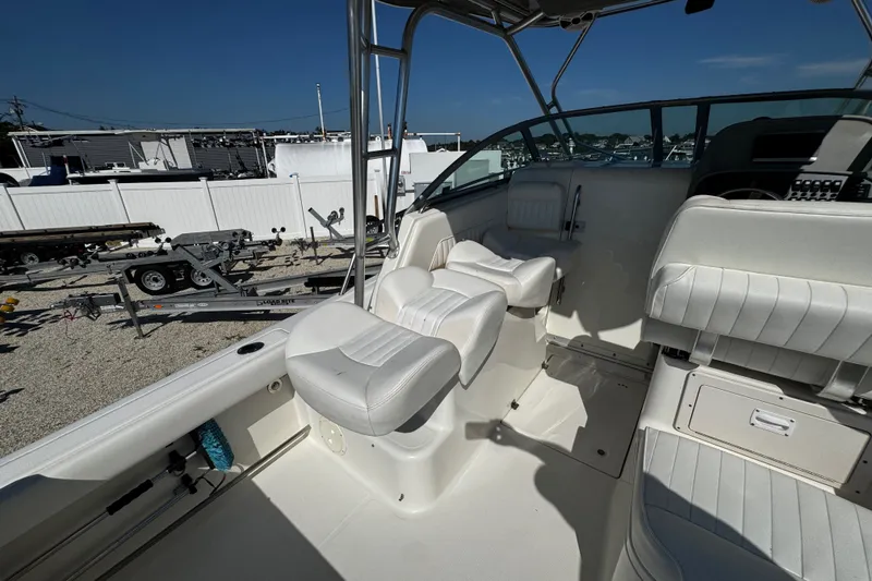 Slide: The Image of 2010 Robalo R265 Walkaround boat interior with white seating and steering area. - 39