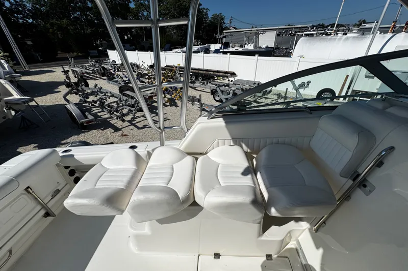 Slide: The Image of 2010 Robalo R265 Walkaround boat interior with white seating and outdoor view. - 38