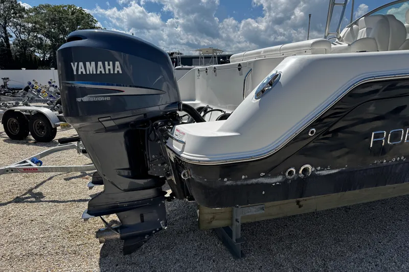 Slide: The Image of 2010 Robalo R265 Walkaround with Yamaha outboard motor, parked on gravel. - 53
