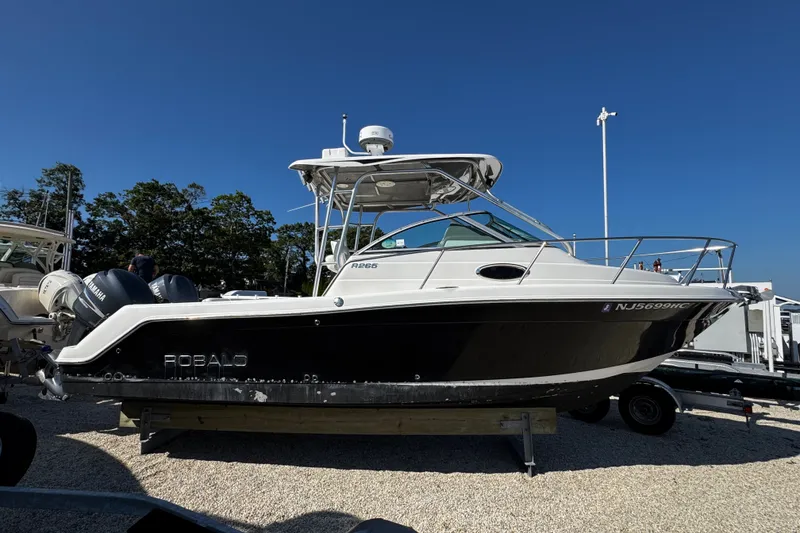 Slide: The Image of 2010 Robalo R265 Walkaround boat with dual Yamaha engines on display. - 1