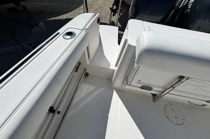 Slide: The Image of 2010 Robalo R265 Walkaround boat interior with white seating and storage compartments. - 16