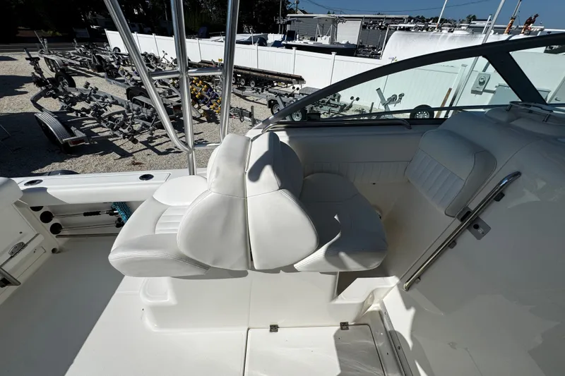 Slide: The Image of 2010 Robalo R265 Walkaround boat interior with white seating and steering area. - 32