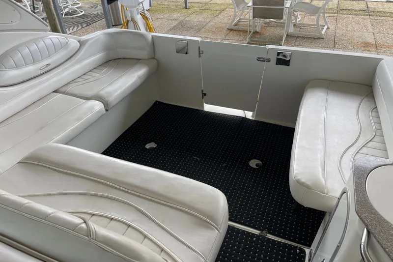 Slide: The Image of Interior of 2000 Maxum 3200 SCR boat with white seating and black carpet. - 10