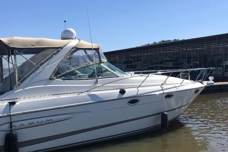 Slide: The Image of 2000 Maxum 3200 SCR boat docked in marina, side view. - 3