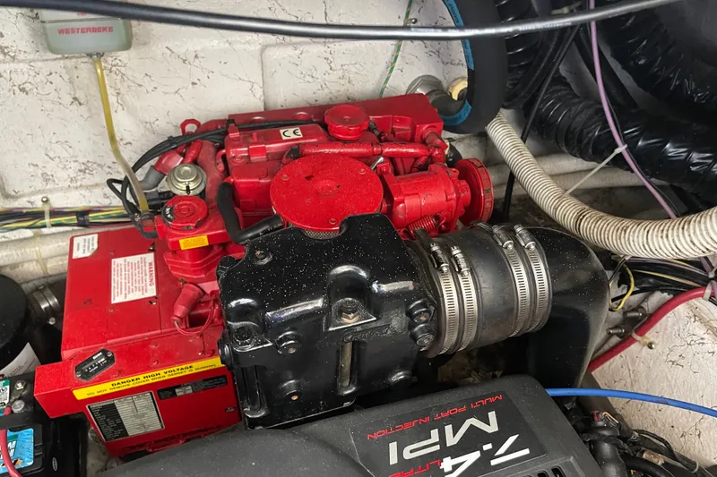 Slide: The Image of Engine compartment of a 2000 Maxum 3200 SCR boat, featuring a red Westerbeke generator. - 23