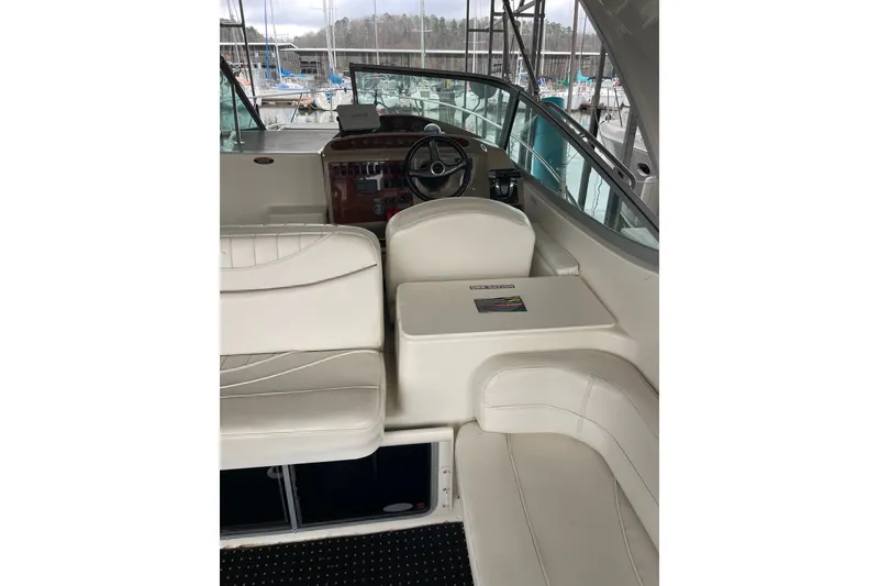 Slide: The Image of 2000 Maxum 3200 SCR boat interior with white seating and steering console. - 8