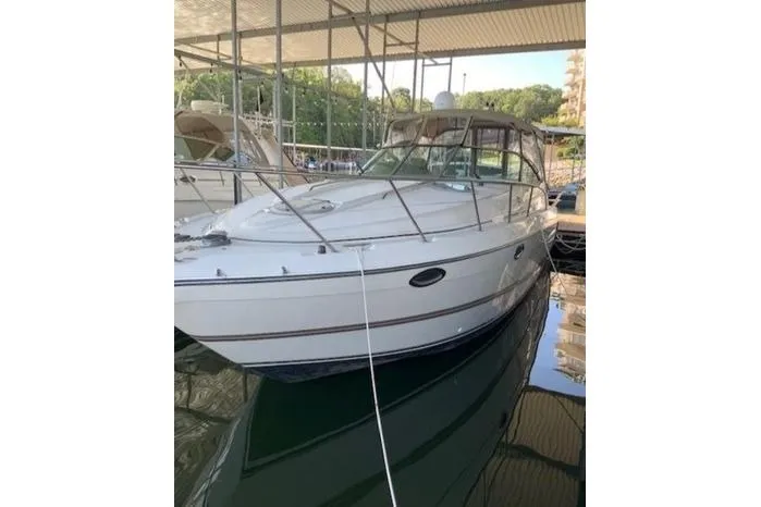 Slide: The Image of 2000 Maxum 3200 SCR boat docked under a covered marina. - 2
