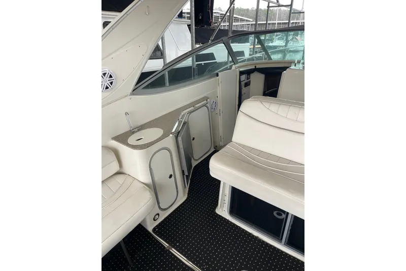 Slide: The Image of Interior of 2000 Maxum 3200 SCR boat with white seating and storage compartments. - 9