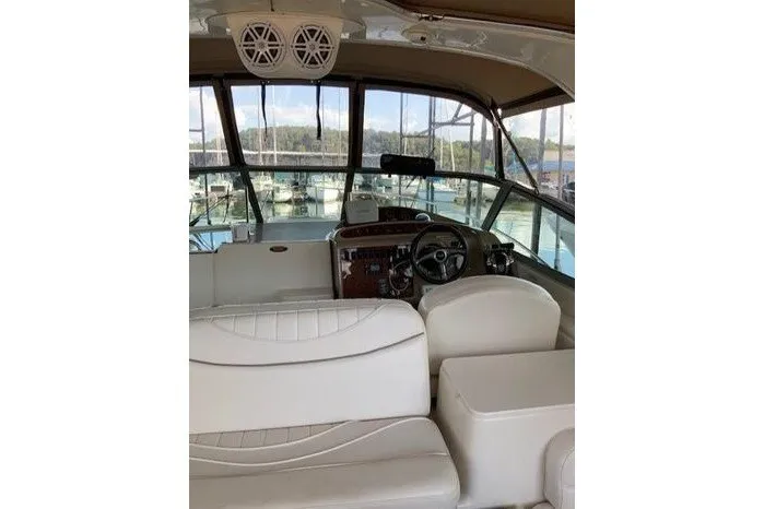 Slide: The Image of Interior view of a 2000 Maxum 3200 SCR boat, featuring a spacious cockpit and helm. - 6