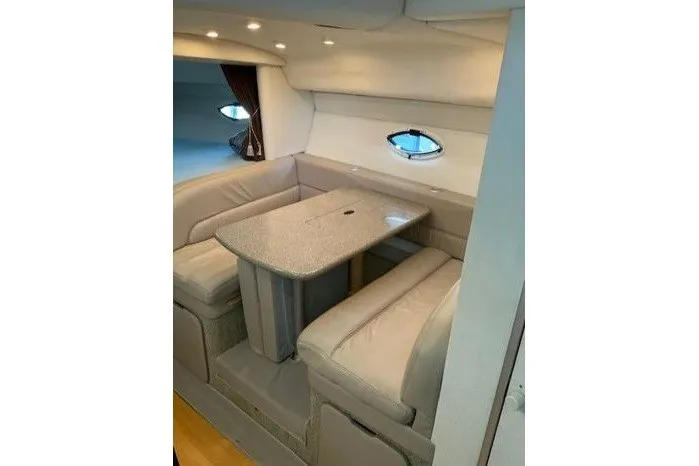 Slide: The Image of Interior of 2000 Maxum 3200 SCR yacht with cozy dining area and plush seating. - 12
