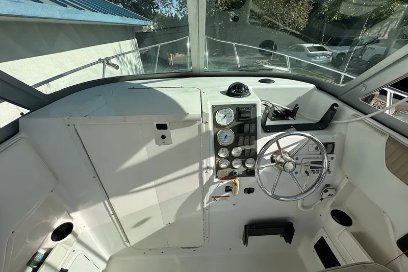 Slide: The Image of 2005 Seaswirl Striper 2301 Walkaround I/O boat cockpit with steering wheel and gauges. - 19