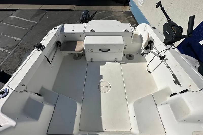 Slide: The Image of 2005 Seaswirl Striper 2301 Walkaround I/O boat interior, featuring spacious deck and fishing equipment. - 18