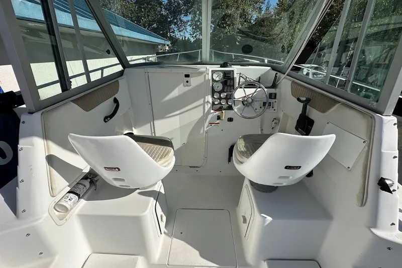 Slide: The Image of 2005 Seaswirl Striper 2301 Walkaround I/O boat interior with helm and seating. - 13