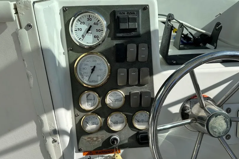 Slide: The Image of Dashboard of a 2005 Seaswirl Striper 2301 Walkaround I/O boat with gauges and steering wheel. - 22