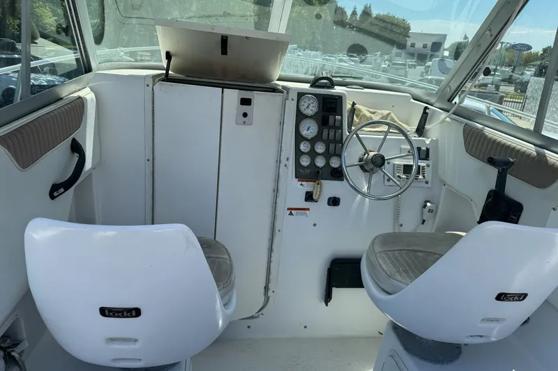 Slide: The Image of 2005 Seaswirl Striper 2301 Walkaround I/O boat interior with steering wheel and gauges. - 12