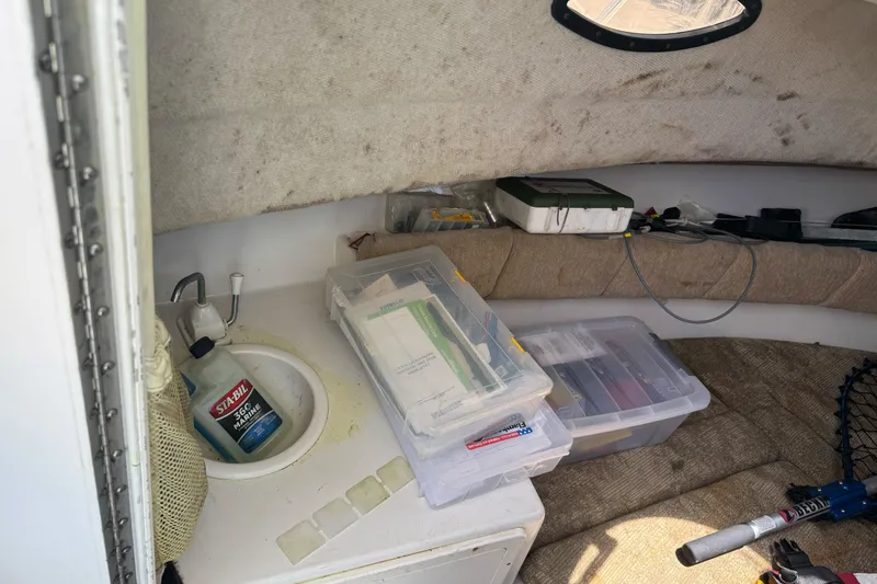 Slide: The Image of Interior of 2005 Seaswirl Striper 2301 Walkaround I/O with storage and cleaning supplies. - 16