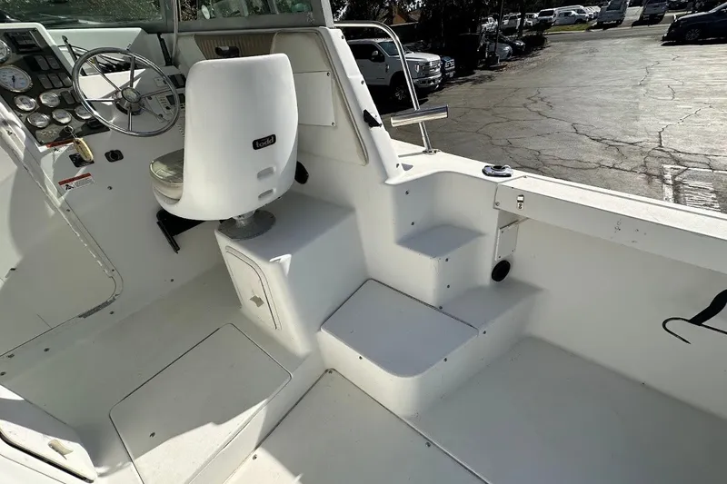 Slide: The Image of 2005 Seaswirl Striper 2301 Walkaround I/O boat interior with steering wheel and seating. - 24
