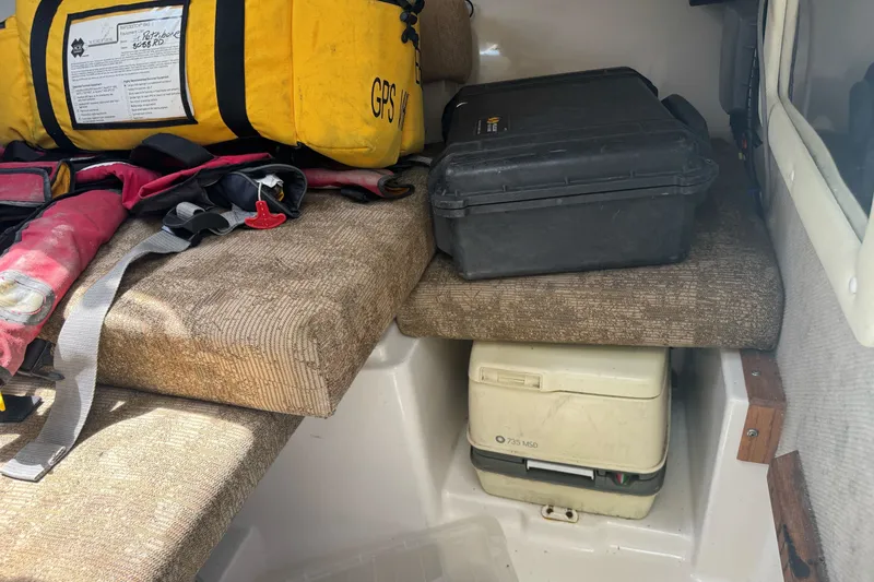 Slide: The Image of Interior of 2005 Seaswirl Striper 2301 with safety gear and storage compartments. - 19