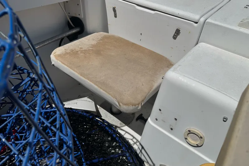 Slide: The Image of 2005 Seaswirl Striper 2301 Walkaround I/O boat interior with seat and fishing gear. - 21