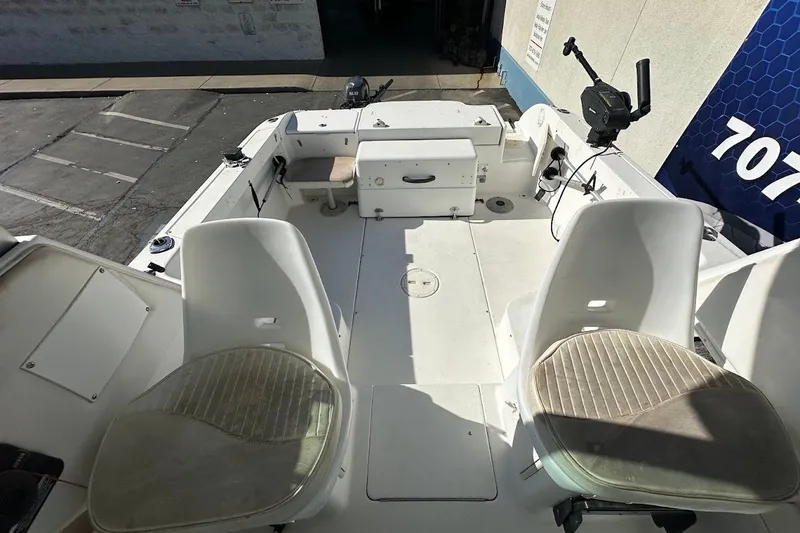 Slide: The Image of 2005 Seaswirl Striper 2301 Walkaround I/O boat interior with seating and fishing equipment. - 16