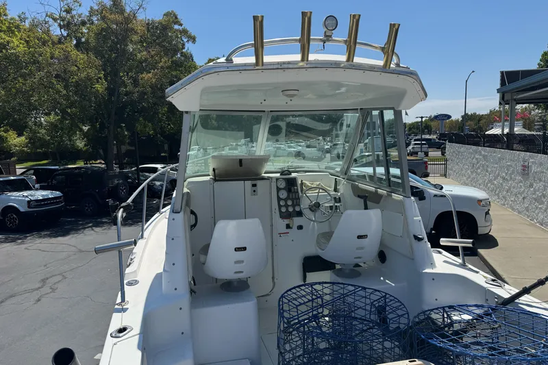 Slide: The Image of 2005 Seaswirl Striper 2301 Walkaround I/O boat with cockpit view and fishing gear. - 10